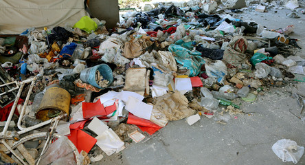 broken dirty objects after the eviction of homeless shelter