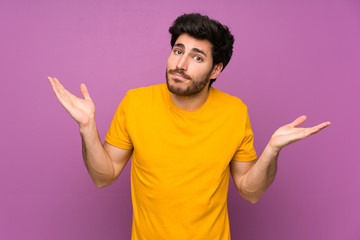 Handsome over isolated purple wall making doubts gesture