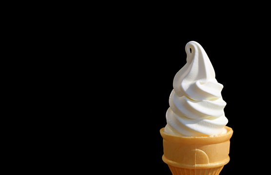 Milk Soft Serve Ice Cream Cone Isolated On Black Background With Free Space For Text And Design