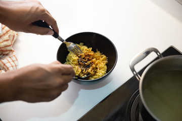cooking instant noodle in the kitchen with boiled water