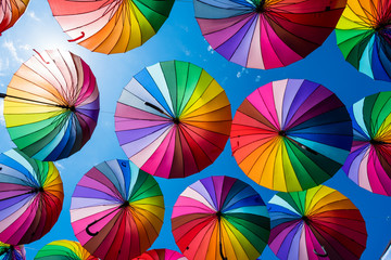 Many colorful umbrellas. Rainbow gay pride protection - obrazy, fototapety, plakaty