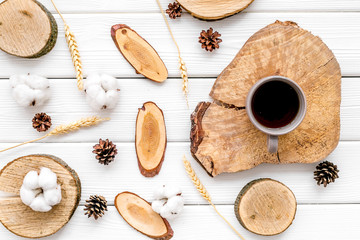 Tree stumps, coffee, immortelle and cones for presentation background top view pattern