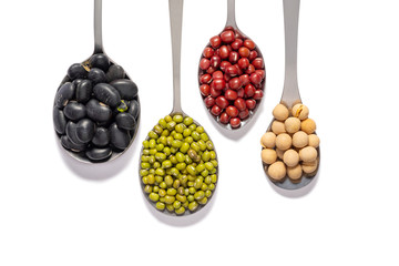 varieties of beans in iron spoons