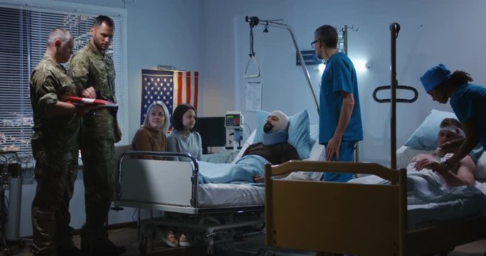 Injured soldier receives badge of honor in hospital
