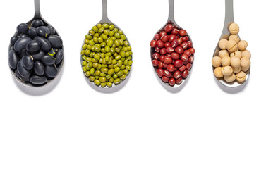 varieties of beans in iron spoons