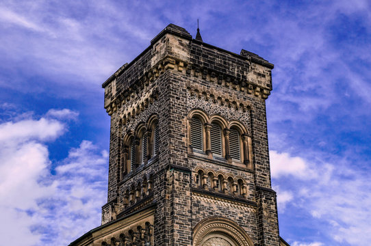Old gothic tower in front of cloudy blue sky
