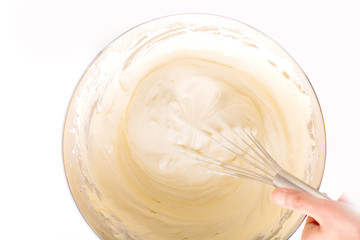 Baking bakery concept whipped eggs mix with ingredients for homemade sponge cake on white background