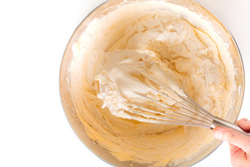 Baking bakery concept whipped eggs mix with ingredients for homemade sponge cake on white background