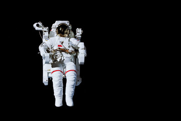 Astronaut with a jetpack isolated on black background with copy space -  Elements of this image are furnished by NASA © Delphotostock