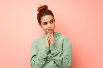 Young redhead woman with sweatshirt scheming something