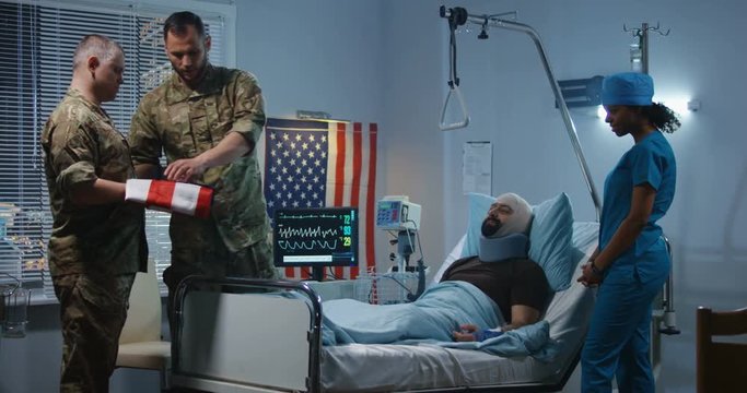 Injured soldier receives badge of honor in hospital