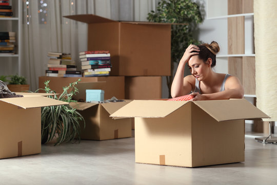 Sad Evicted Tenant Moving Home Boxing Belongings