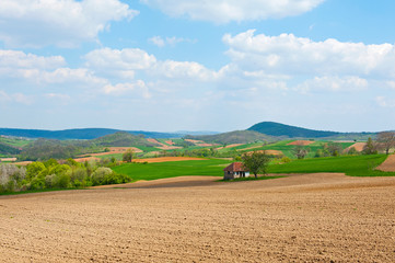Field and green mountains view at sunny day