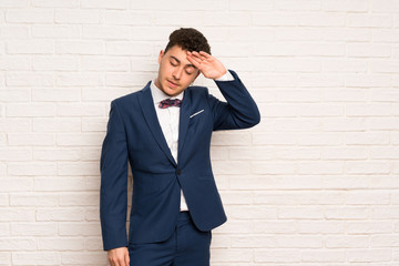 Man in suit and bow tie with tired and sick expression