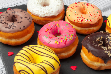 Glazed colored donuts background image. Macro shot