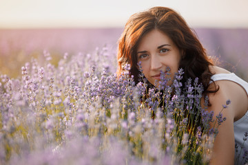 Portrait of a beautiful brunette in a lavender field.