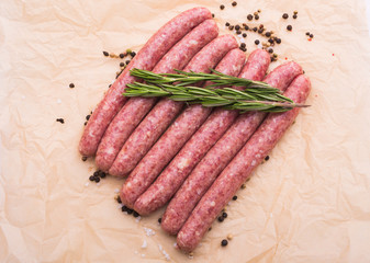 Food and delicious concept - raw horse meat sausage