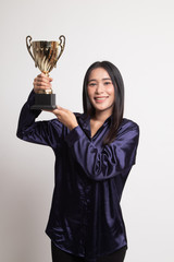 Successful young asian woman holding a trophy.