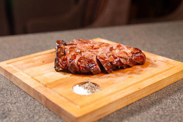 food, delicious and craft concept - cutting horse meat steak on wooden desk