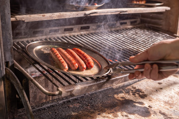 food, delicious and meat concept - roasting horse meat sausages grilled.