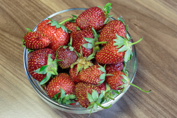 Fresh strawberry in the glass bowl closeup. Concept of a vegan breakfast.