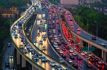 Traffic jam in the rush hour on highway. Cars on bridges and roads in Shanghai Downtown, China at...