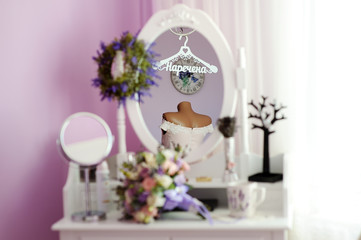 wedding bouquet and cup of tea on the bedside table with mirror