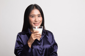 Healthy Asian woman drinking a glass of milk.