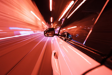 Obraz na płótnie Canvas POV of car driving at night city with motion blur