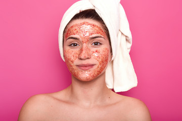 Indoor studio shot of young attractive woman with white towel on her head, has naked body, smilling...