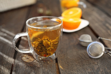 Blossoming green tea, a glass of hot aromatic drink.