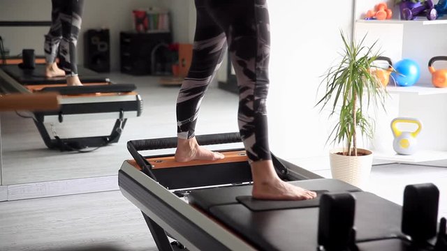 Close up of a womans feet doing reformer pilates