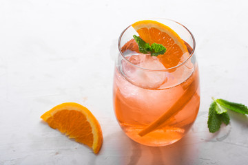 Fresh ice tea summer cocktail with orange and ice