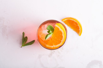 Fresh ice tea summer cocktail with orange and ice
