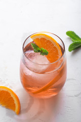 Fresh ice tea summer cocktail with orange and ice