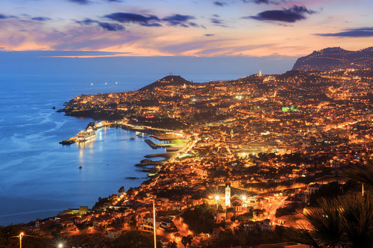 Beautiful skyline cityscape aerial view from the hill of the city Funchal on the island Madeira at sunset in summer