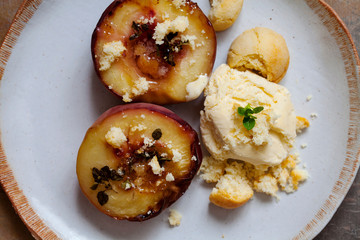 Baked peaches with ice cream and amaretti biscuit