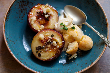 Baked peaches with ice cream and amaretti biscuit