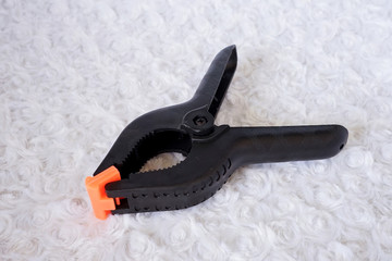 Obraz premium Wooden spring clamp on a white background. Woodworking tools equipment for industry and production.