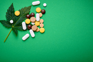 pills and cannabis leaf. the idea of alternative medicine