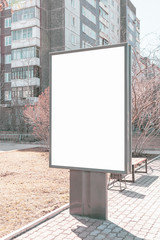 Vertical small billboard in the city on the sidewalk. Mock up for your advertising or announcements