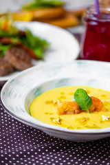 shrimp corn soup in the background steak