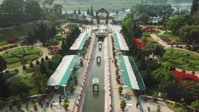 Aerial overall plan Da Lat Flower Park city thousand flowers most popular landmark soigne garden. Flowerbeds exotic colorful flowers plants fountain people tourists walk. Sunny day. Vietnam sight