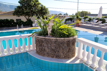 Fototapeta na wymiar Swimming pool design modern architecture of luxury holiday villa. Relax near exotic swimming pool with handrail, deck chairs, sun loungers and parasols waiting for tourists in tropical resort hotel.