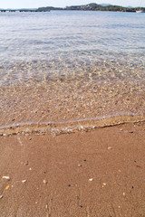 Exotic sandy beach, tropical blue mediterranean sea with waves and sea foam. Beautiful natural environment, panorama, landscape. Idyllic seaside resort in summer season, paradise and amazing scene.