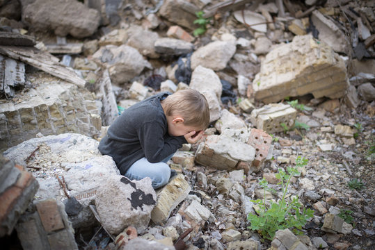 boy crying among the ruins