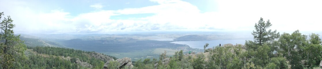Obraz premium panoramic view from the top of the mountain to the mountain expanses with a lake