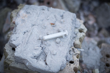 syringe in the ruins of an abandoned place
