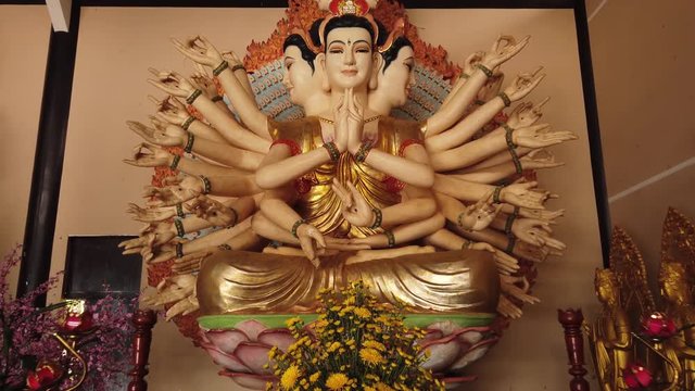 Many-armed many faces god giant Shiva symbol religious buddhism deity statue sculpture altar close hands inside the temple. Authentic mythological Asia. Gimbal forward