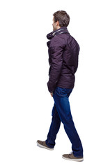 Side view of going handsome man in jeans and jacket.